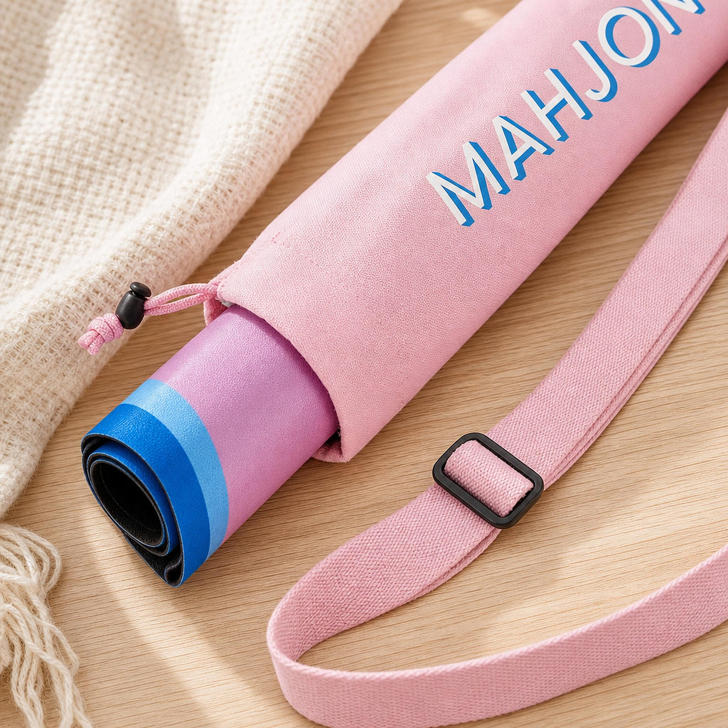 Close-up of light pink mahjong mat carry bag holding a rolled mahjong mat, drawstring and strap detail