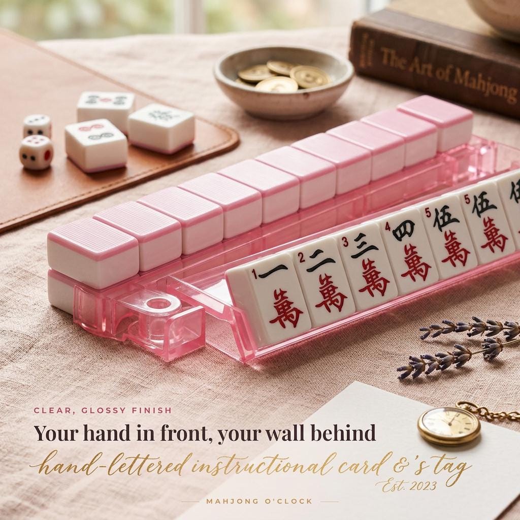 Pink mahjong rack holding tiles with pusher