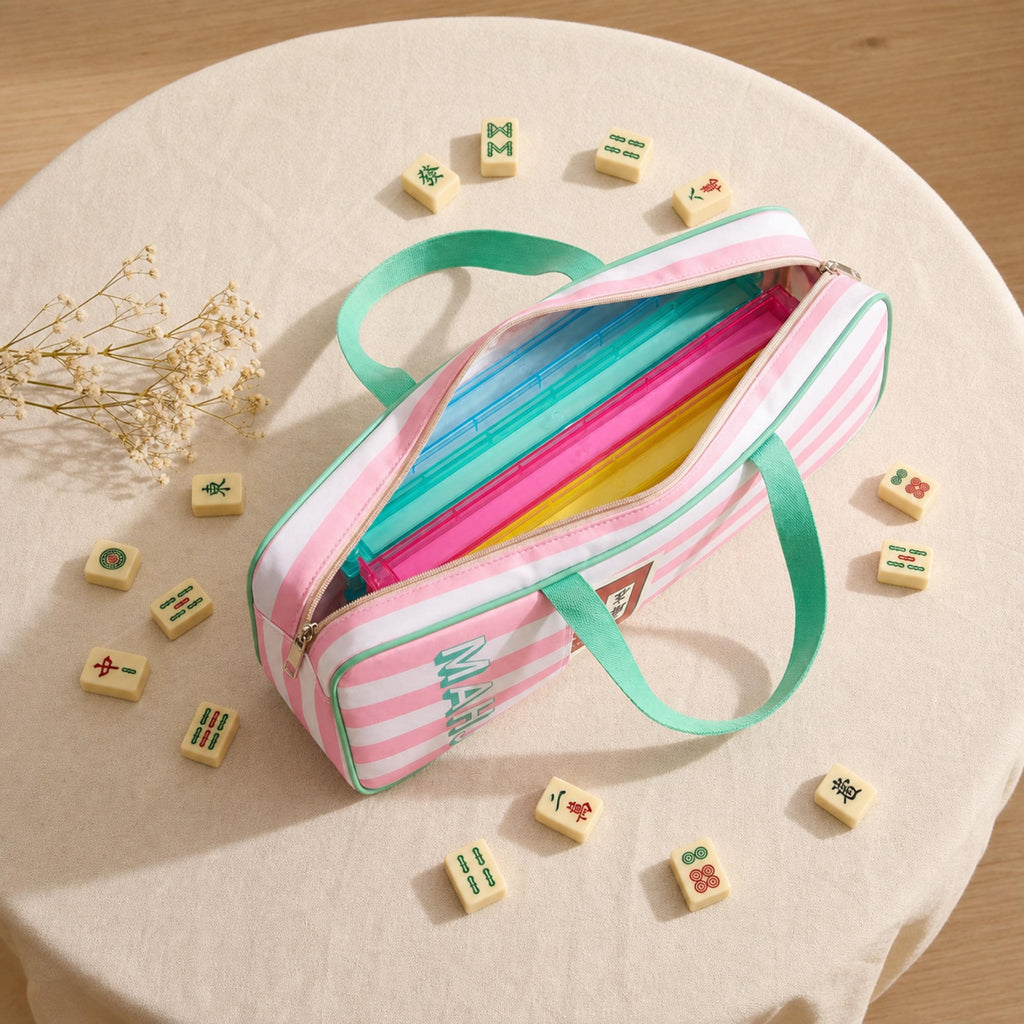 Open pink striped mahjong rack bag holding colorful racks, surrounded by mahjong tiles